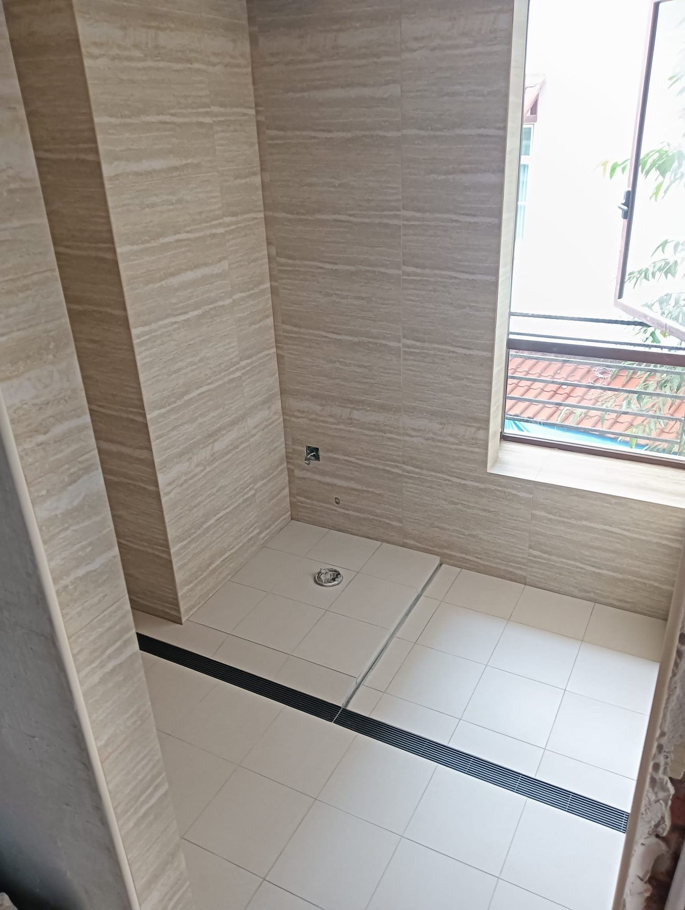 Retiled shower area with new floor trap